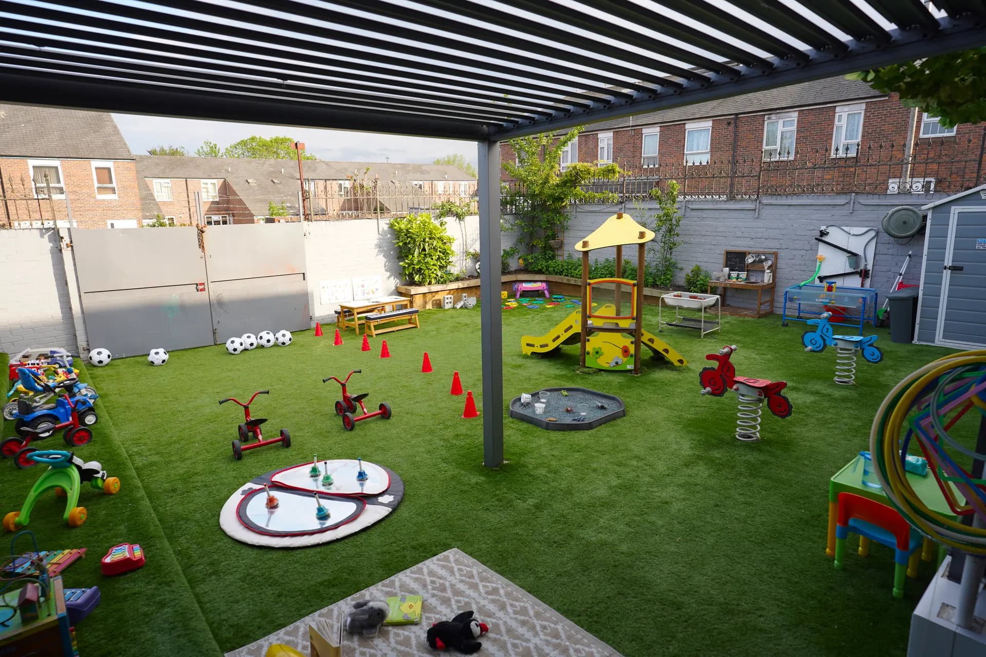 Outdoor learning playground under the pergola at Blue Nest Borehamwood