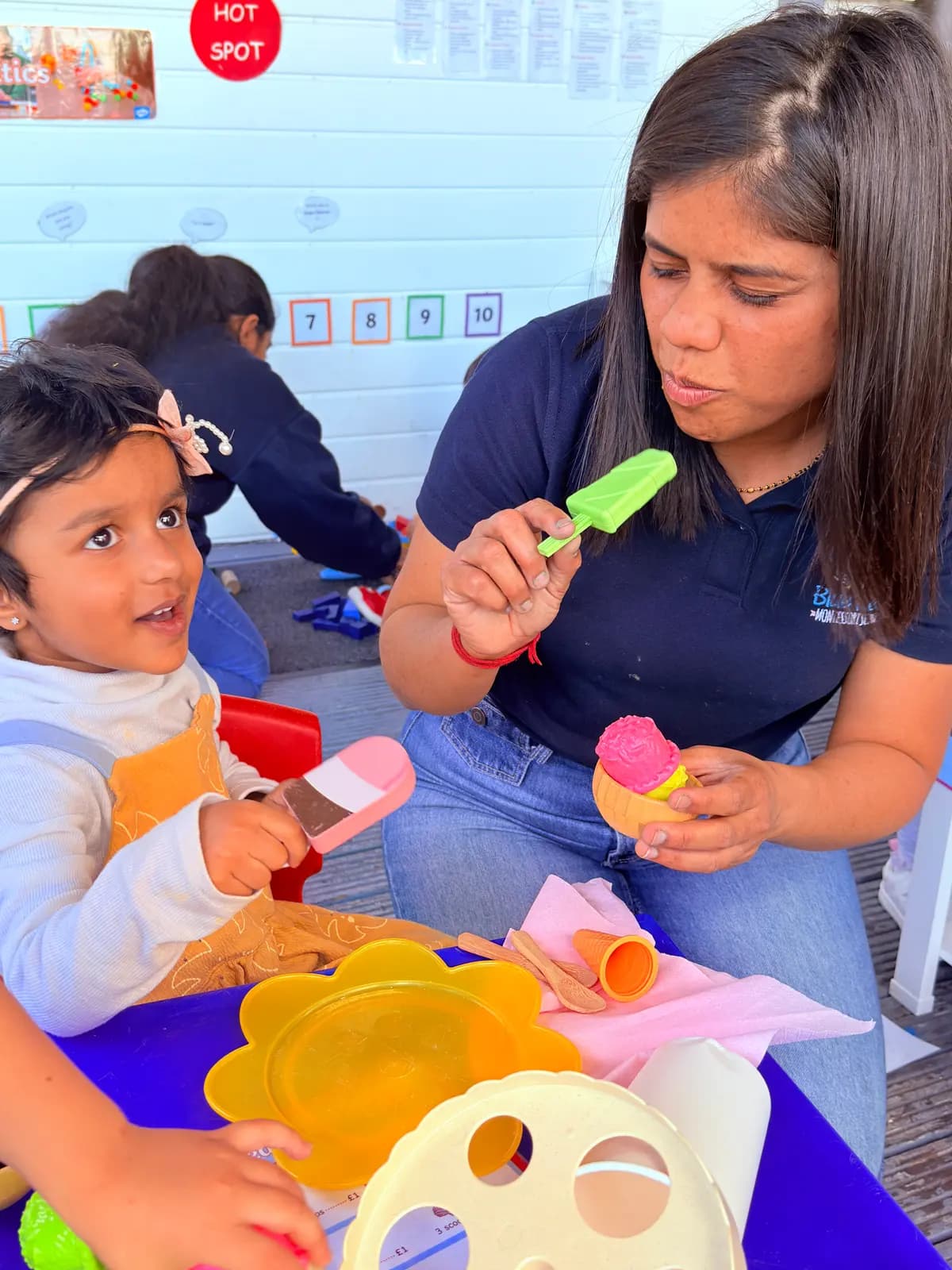 A Blue Nest Montessori Harrow teacher at play with a young child