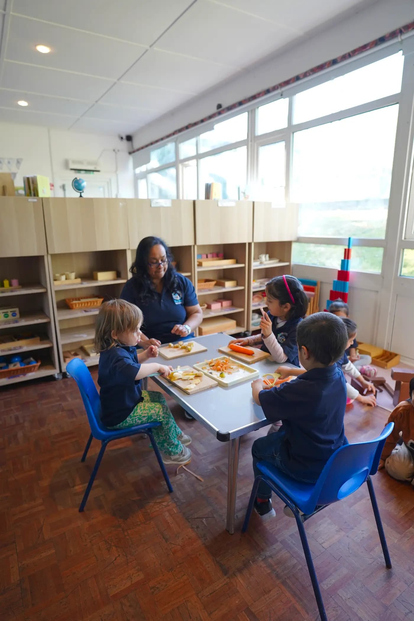 Children at a Montessori real-food prep table at Blue Nest Pinner